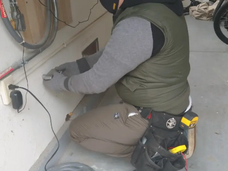 Electrician performing outlet wiring in a Moorestown garage